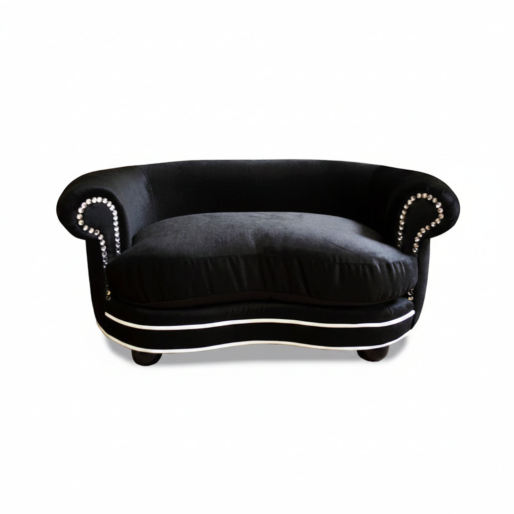 Black sofa with decorative trim on a white background