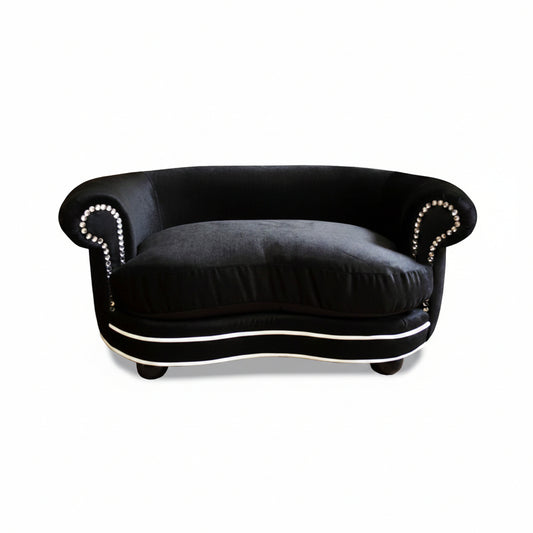 Black sofa with decorative trim on a white background