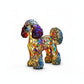 Colorful stained glass dog sculpture on a white background