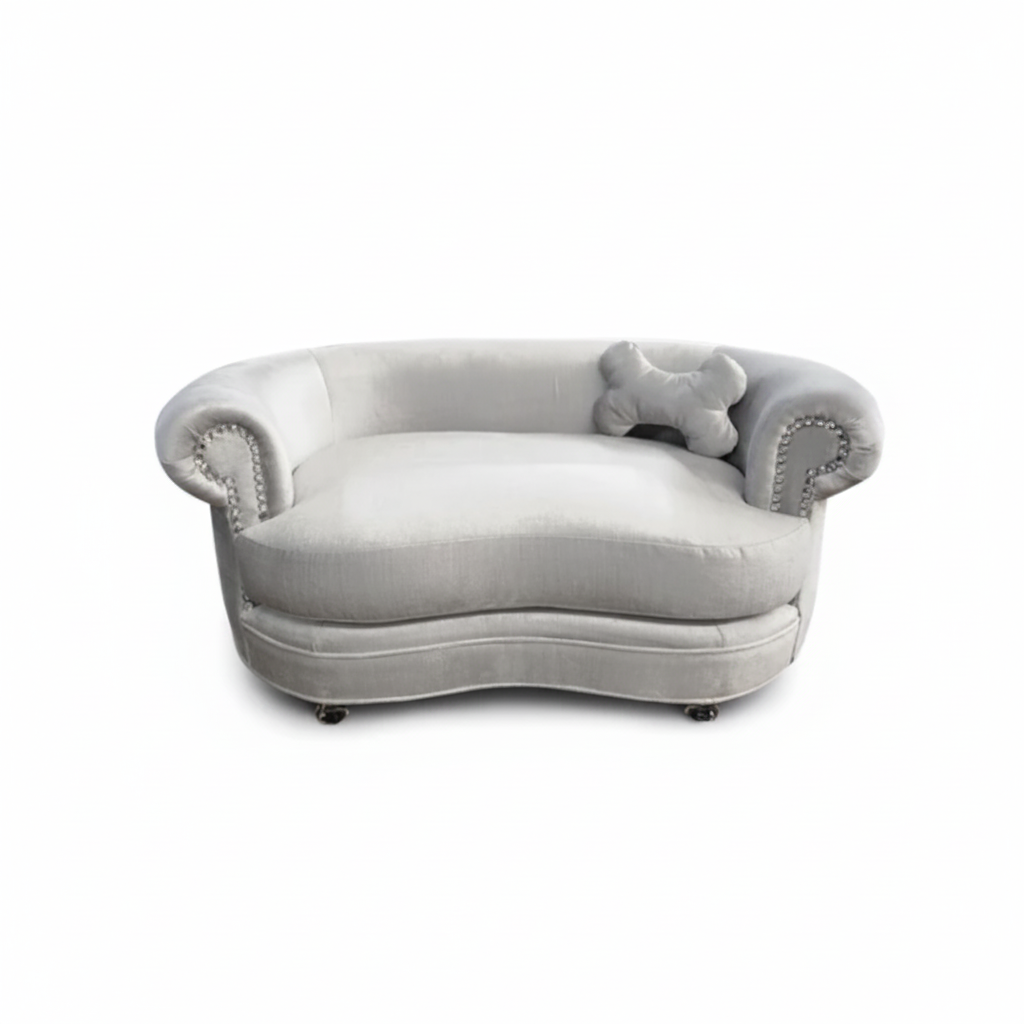 Gray plush dog bed with decorative armrests on a white background