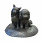 Bronze statue of two a dog and a cat on a white background