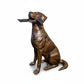 Bronze statue of a dog holding a stick on a white background