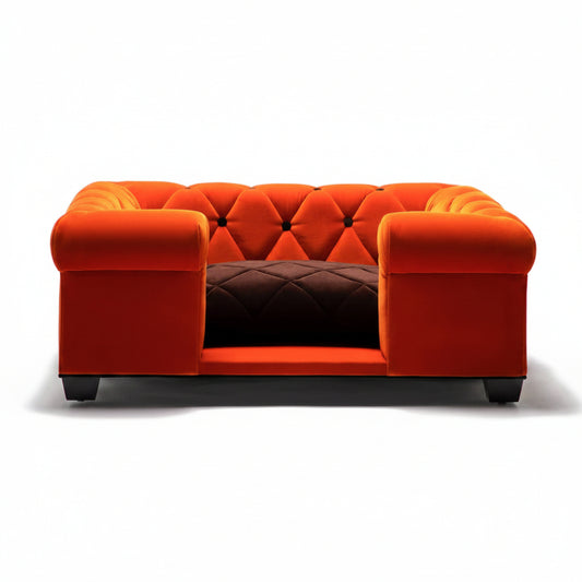 Orange tufted sofa with a brown quilted cushion on a white background