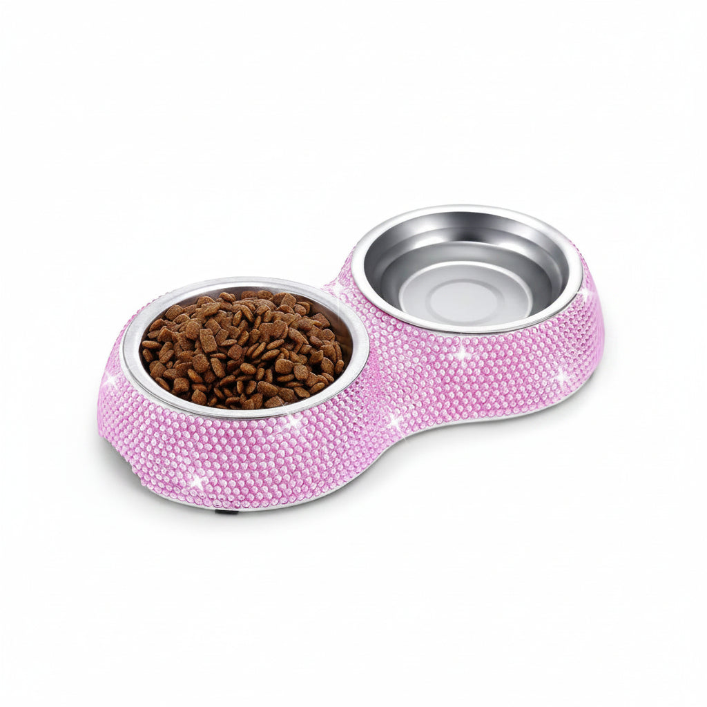Pink pet bowl with two compartments, one filled with kibble, on a white background